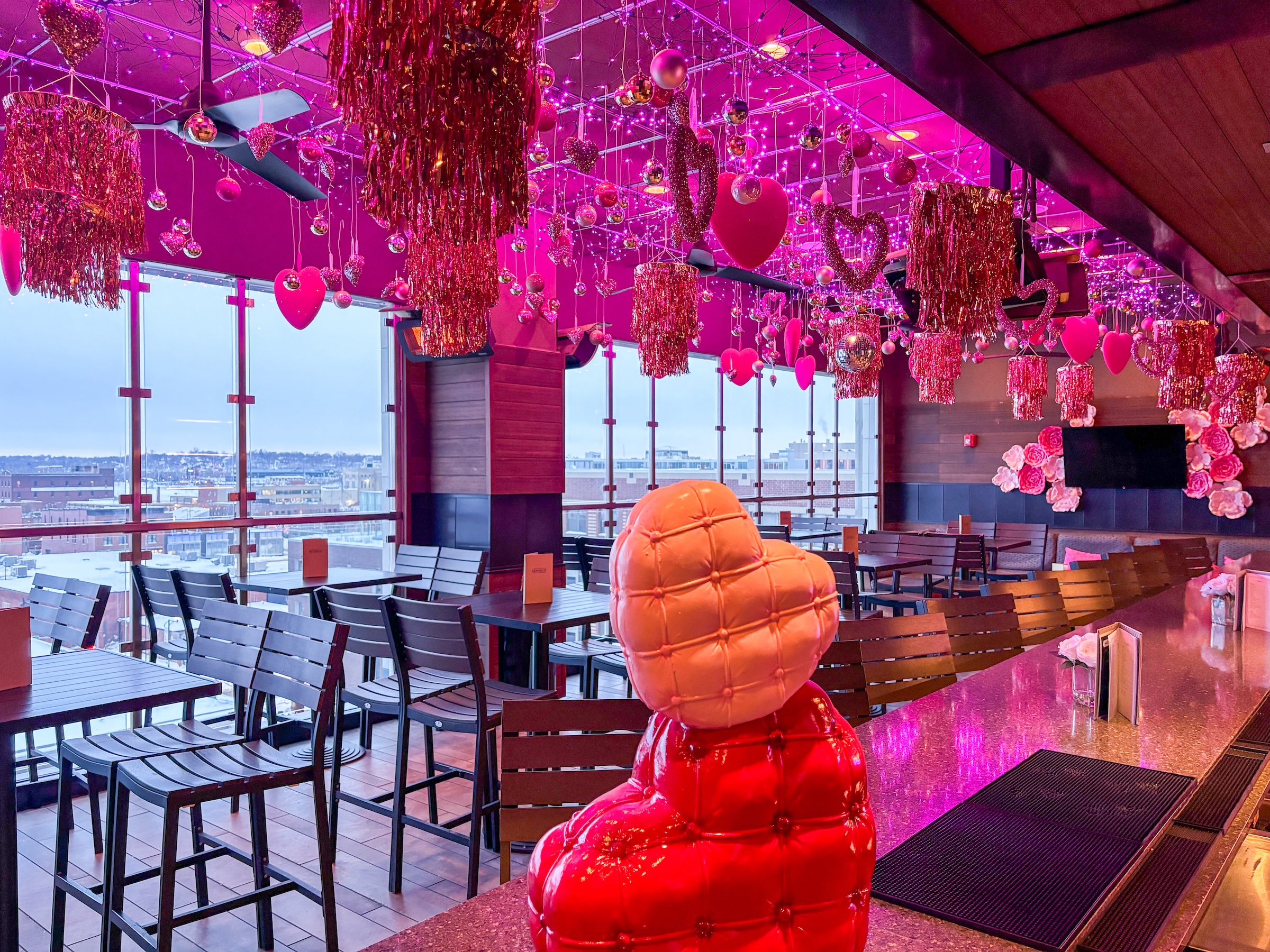 The Republic on Grand decorated with pink string lights and heart shaped ornaments hanging from the ceiling